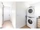 Bright laundry room featuring a stacked washer and dryer near doorway at 1330 E Monte Vista Rd, Phoenix, AZ 85006