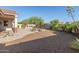 Spacious backyard with outdoor kitchen, fire pit, gravel beds and desert plants at 13583 S 177Th Ln, Goodyear, AZ 85338