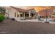 Backyard with stylish patio area, stone columns, built-in seating, and desert landscaping at 13583 S 177Th Ln, Goodyear, AZ 85338