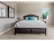 The main bedroom features a large bed, and neutral walls and carpeting at 13583 S 177Th Ln, Goodyear, AZ 85338