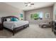This bedroom features large windows, a ceiling fan, and neutral carpeting at 13583 S 177Th Ln, Goodyear, AZ 85338