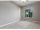 A cozy bedroom with a window offering natural light, carpeted floors, and a ceiling fan at 13583 S 177Th Ln, Goodyear, AZ 85338