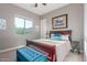 Comfortable bedroom boasts a large bed, a bright window, and soft carpeting for a cozy and inviting space at 13583 S 177Th Ln, Goodyear, AZ 85338