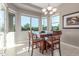 Bright dining area with a stylish chandelier, large windows, and modern decor at 13583 S 177Th Ln, Goodyear, AZ 85338