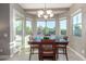 Inviting dining room with a square table, comfortable chairs, and abundant natural light at 13583 S 177Th Ln, Goodyear, AZ 85338