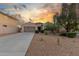 Charming single-story home boasting a desert landscape and a two-car garage, set against a picturesque sunset at 13583 S 177Th Ln, Goodyear, AZ 85338