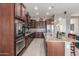 This kitchen features granite countertops, stainless steel appliances, and an island with pendant lighting at 13583 S 177Th Ln, Goodyear, AZ 85338