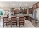 This kitchen showcases granite countertops, stainless steel appliances, and seating at the island at 13583 S 177Th Ln, Goodyear, AZ 85338