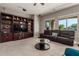 Comfortable living room with custom built-ins, a plush sofa, and a large picture window at 13583 S 177Th Ln, Goodyear, AZ 85338