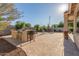 Outdoor kitchen featuring a built-in grill, bar seating, and a spacious patio perfect for entertaining guests at 13583 S 177Th Ln, Goodyear, AZ 85338