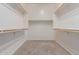 This walk-in closet features neutral carpeting and plenty of hanging space at 13583 S 177Th Ln, Goodyear, AZ 85338