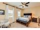 Bedroom with a ceiling fan, bright windows, and a comfortable sitting area at 1367 S Country Club Dr # 1127, Mesa, AZ 85210