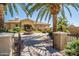 Stunning front exterior featuring a circular driveway, lush greenery, and water fountain at 1367 S Country Club Dr # 1127, Mesa, AZ 85210