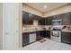 Kitchen with stainless steel appliances, granite countertops, and dark wood cabinets at 1367 S Country Club Dr # 1127, Mesa, AZ 85210