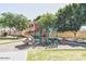Community playground with slide and climbing structure, surrounded by trees and green space at 1367 S Country Club Dr # 1127, Mesa, AZ 85210
