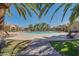 A resort-style pool area with lounge chairs and landscaping, surrounded by residential buildings at 1367 S Country Club Dr # 1127, Mesa, AZ 85210