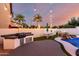 Backyard features a built-in grill, a picnic table, and a custom pool with waterfall at 1429 E Lowell Ave, Gilbert, AZ 85295