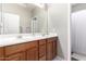 Well-lit bathroom featuring a double sink vanity and a shower/tub combo at 1429 E Lowell Ave, Gilbert, AZ 85295