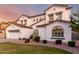 Charming two-story home featuring a well-maintained lawn, arched entryway, and a three-car garage at 1429 E Lowell Ave, Gilbert, AZ 85295