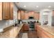 Stylish kitchen featuring wood cabinets, granite countertops, and stainless steel appliances at 1429 E Lowell Ave, Gilbert, AZ 85295