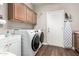 Convenient laundry room features a front-load washer and dryer and upper cabinets at 1429 E Lowell Ave, Gilbert, AZ 85295