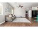 Living room with hardwood floors, a gray sofa, and natural light from the windows at 1429 E Lowell Ave, Gilbert, AZ 85295