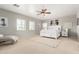 Bright main bedroom with carpet, white furniture, natural light, and ceiling fan at 1429 E Lowell Ave, Gilbert, AZ 85295