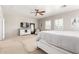 Relaxing main bedroom features a ceiling fan, dresser with a TV, and plantation shutters at 1429 E Lowell Ave, Gilbert, AZ 85295