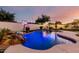 Custom pool with rock waterfall feature and lush landscaping in this lovely backyard at 1429 E Lowell Ave, Gilbert, AZ 85295