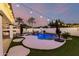 Beautiful backyard pool with lush landscaping, waterfall feature, and basketball hoop at 1429 E Lowell Ave, Gilbert, AZ 85295