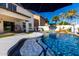 The backyard has a sparkling pool with mature landscaping and a covered patio, ideal for outdoor living and recreation at 1429 E Lowell Ave, Gilbert, AZ 85295