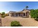 Backyard view of screened-in patio with desert landscaping and clear blue skies at 15801 W Goldenrod Dr, Surprise, AZ 85374