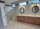 Bright bathroom features dual sinks, tile floors, walk-in shower with tiled accents at 15801 W Goldenrod Dr, Surprise, AZ 85374