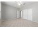 Neutral-toned bedroom with tile floors, a ceiling fan, and closet with sliding doors at 15801 W Goldenrod Dr, Surprise, AZ 85374