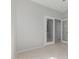 Spare bedroom with tile flooring and double glass doors leading to another room at 15801 W Goldenrod Dr, Surprise, AZ 85374