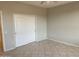 Bedroom featuring tile floors and a closet door at 15801 W Goldenrod Dr, Surprise, AZ 85374