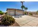 Spacious driveway leading to a three car garage with desert landscaping, cacti and mature trees at 15801 W Goldenrod Dr, Surprise, AZ 85374