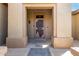 Covered entryway with security door and decorative columns creating a welcoming entrance to the home at 15801 W Goldenrod Dr, Surprise, AZ 85374