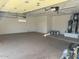 Spacious two car garage features an epoxy floor and high ceilings at 15801 W Goldenrod Dr, Surprise, AZ 85374
