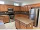 Kitchen with stainless appliances, a central island, and beautiful light wood cabinetry at 15801 W Goldenrod Dr, Surprise, AZ 85374