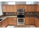 Kitchen showcasing light wood cabinetry, stainless steel appliances, and decorative backsplash at 15801 W Goldenrod Dr, Surprise, AZ 85374