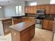 Kitchen featuring light wood cabinets, stainless steel appliances, and tiled flooring at 15801 W Goldenrod Dr, Surprise, AZ 85374
