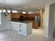 Open kitchen featuring wood cabinets, tile flooring, granite counters, and stainless steel appliances at 15801 W Goldenrod Dr, Surprise, AZ 85374