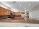 Kitchen with wooden cabinets, stainless steel appliances, granite counters, and breakfast bar for casual dining at 15801 W Goldenrod Dr, Surprise, AZ 85374