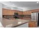 Kitchen featuring wood cabinets, stone countertops, and stainless steel appliances at 15801 W Goldenrod Dr, Surprise, AZ 85374