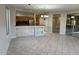 An open kitchen design with tile flooring, wood cabinets and breakfast bar at 15801 W Goldenrod Dr, Surprise, AZ 85374