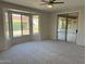 Living room featuring carpet flooring and a sliding door at 15801 W Goldenrod Dr, Surprise, AZ 85374