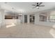 Open-concept living room with tile flooring and adjacent kitchen, perfect for entertaining guests at 15801 W Goldenrod Dr, Surprise, AZ 85374