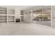Spacious living room with plush carpet, built-in shelving and fireplace creating an inviting space at 15801 W Goldenrod Dr, Surprise, AZ 85374