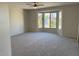 Living room featuring carpet flooring and a large window at 15801 W Goldenrod Dr, Surprise, AZ 85374
